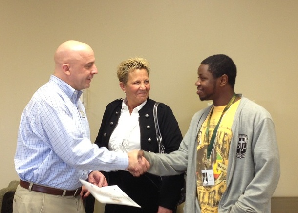 360 Youth Services Housing Director Debbie Carr looks on as Loaves & Fishes CEO congratulates Amari, 360’s first client to receive a certificate of completion of a collaborative program focusing on job readiness skills.