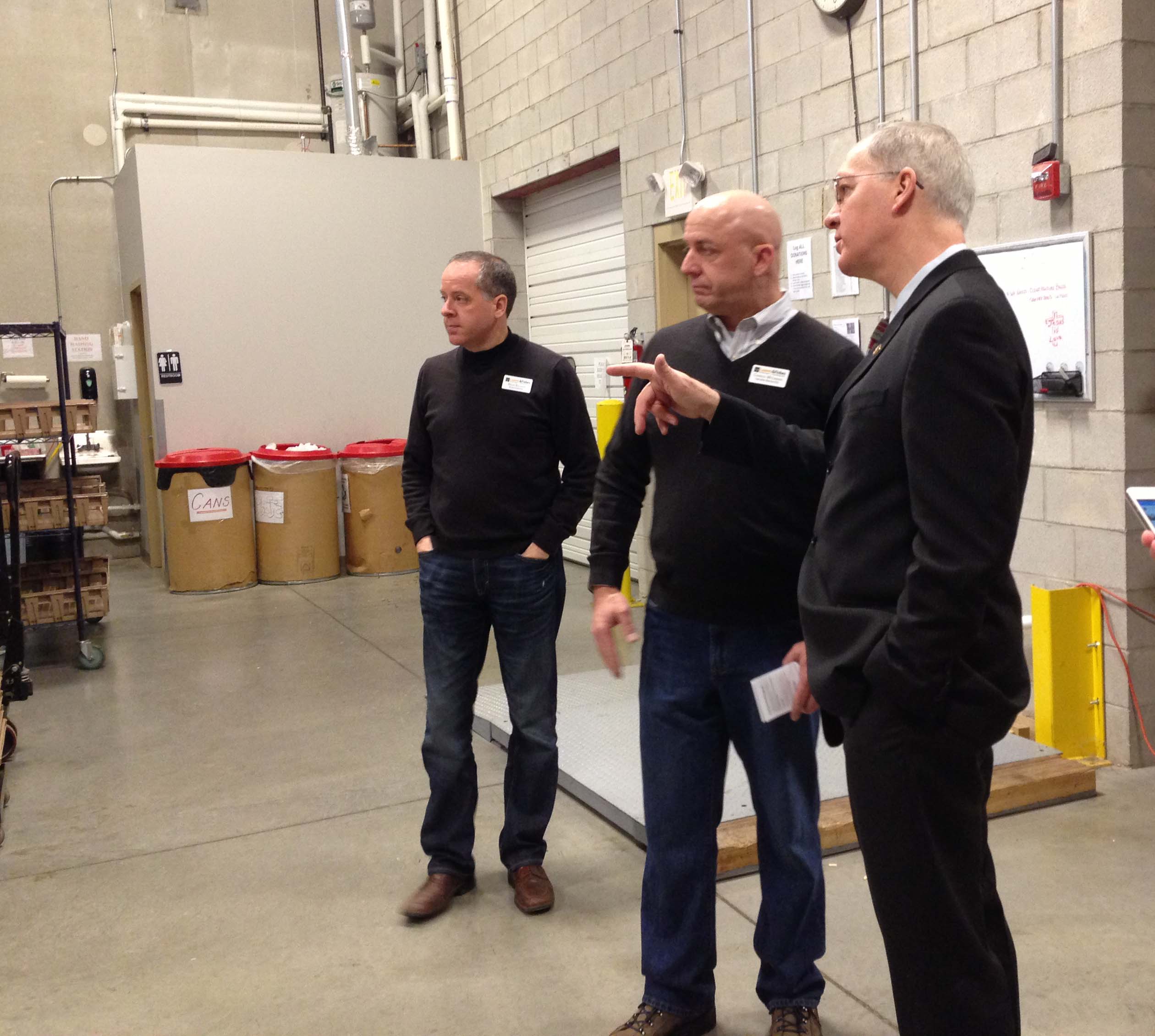 (l-r) Board Member Brian Bolliger, Charles McLimans, Congressman Foster tour the sorting area of warehouse.